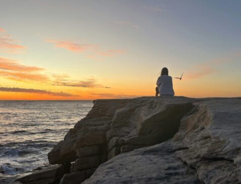 Watching the sunset on the rocks by Miriam Alcorn