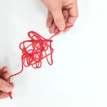 Hands playing with string