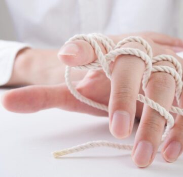 Hands playing with string